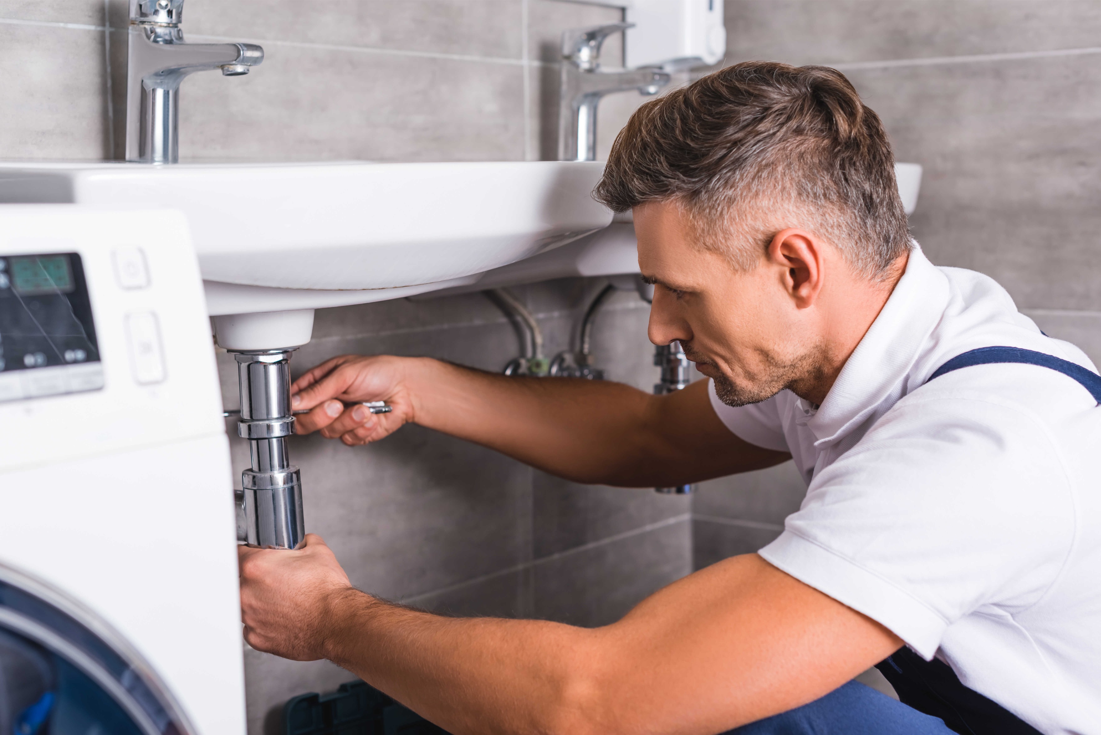 Expert plumber repairing bathroom sink